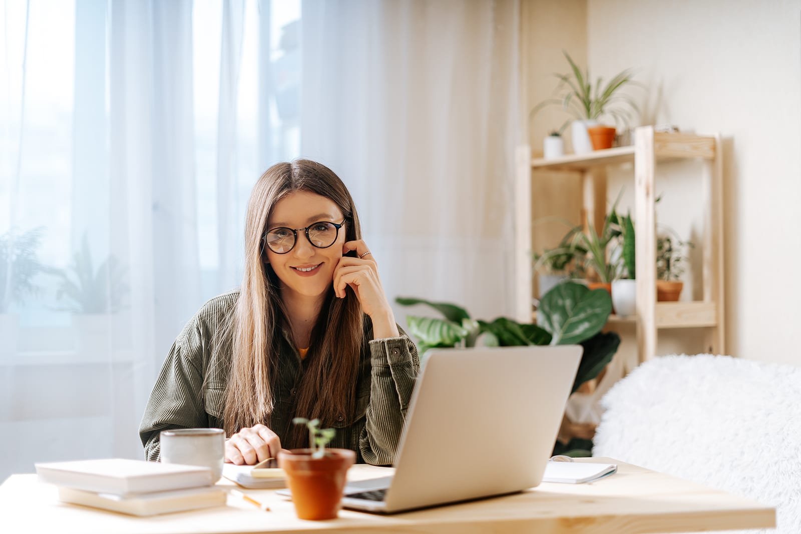 woman with glasses writing content as an organic SEO consultant